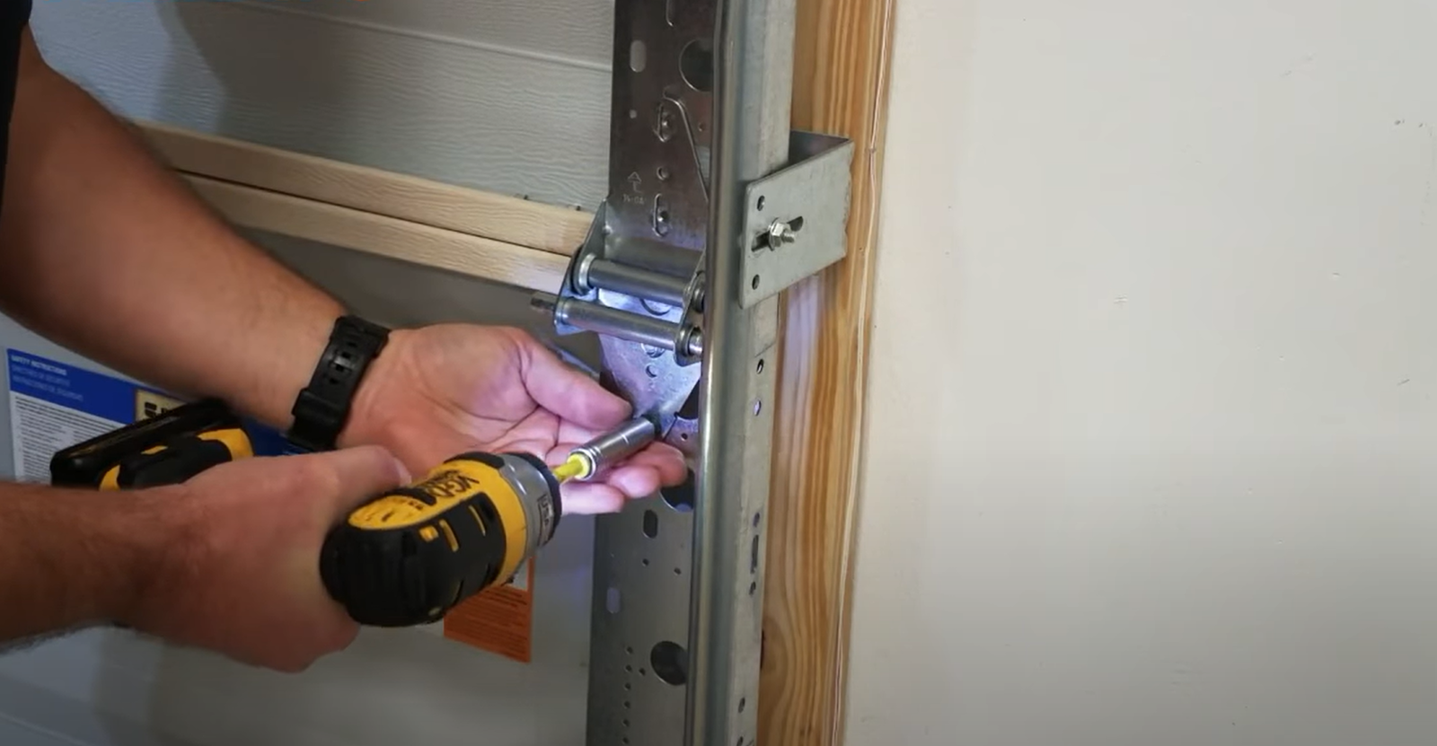 a technician repairing a noisy garage door in Fort Pierce, FL with tools and equipment, highlighting professional garage door repair services.