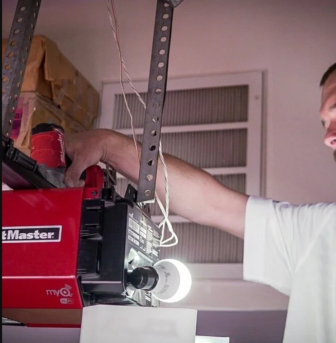 Professional technician performing garage door opener repair in Fort Pierce, FL, ensuring smooth and reliable operation for homeowners.