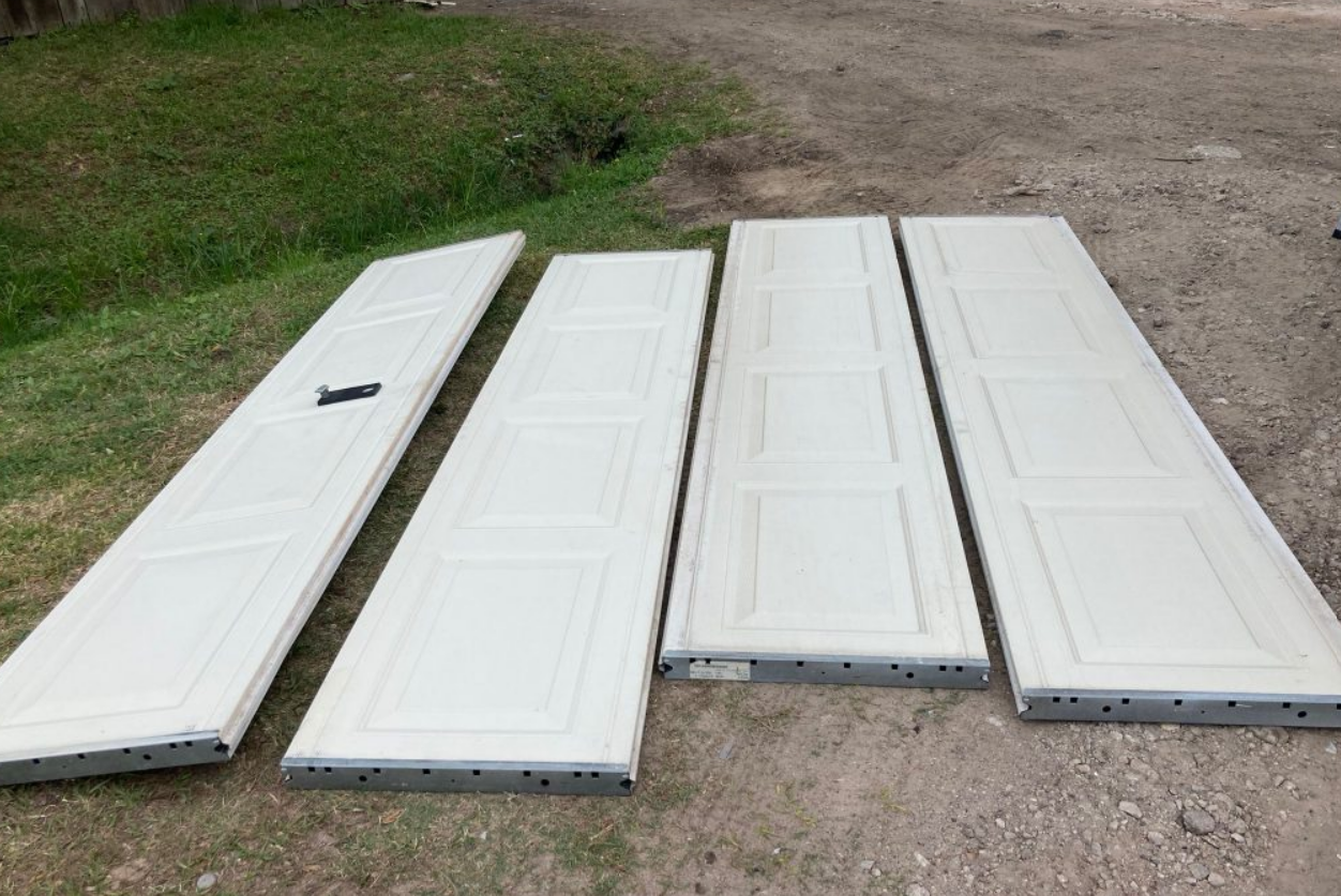 Professional technician performing precise garage door panel repair in Fort Pierce, FL, ensuring efficient and reliable garage door services.