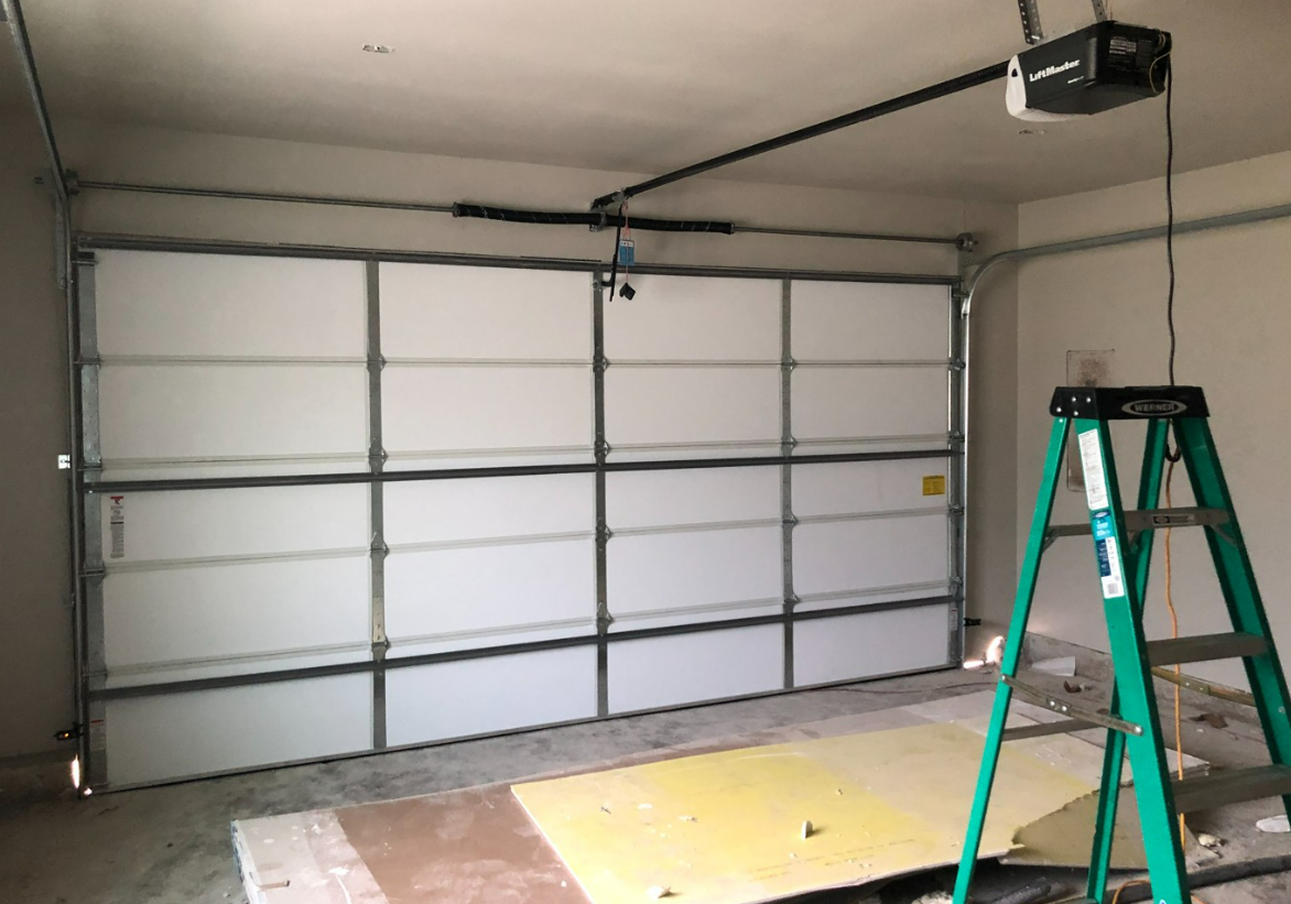 Experienced technician performing a garage door replacement in Fort Pierce, FL - Enhance your home's functionality with our professional garage door repair services.