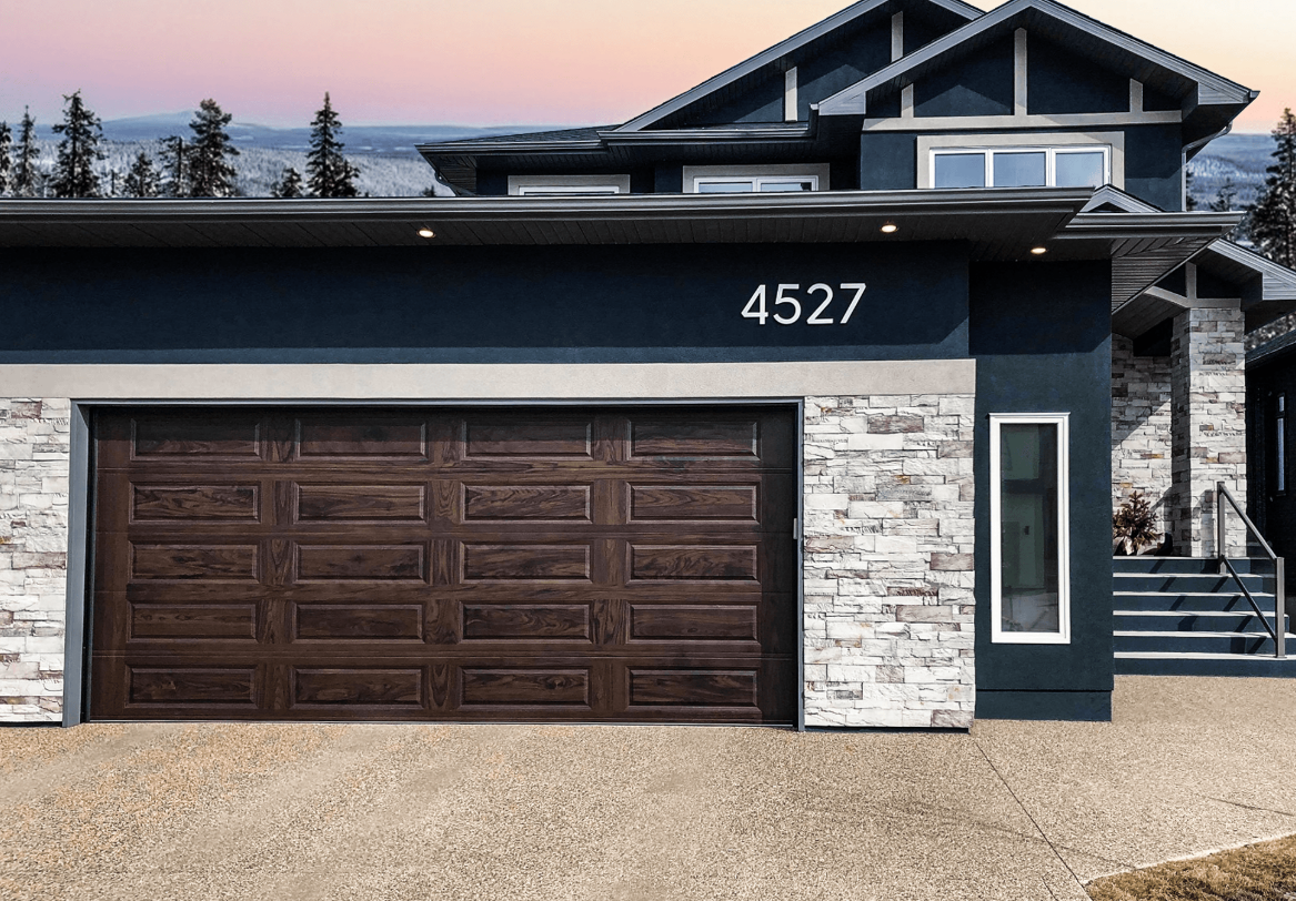 A professional technician repairing a residential garage door in Fort Pierce, FL, showcasing expert skills and high-quality tools, representing premier garage door repair services available in the area.