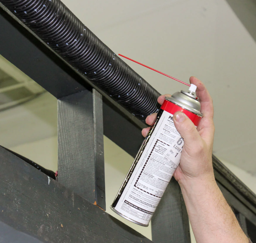 Garage Door Repair Services in Fort Pierce, FL - Expert technicians fixing garage door spring with precision and care.