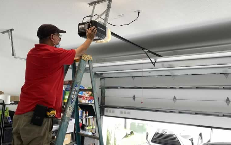 "Image showing a professional technician repairing a garage door opener in Fort Pierce, FL. The technician is carefully adjusting the mechanisms to ensure smooth operation. This garage door opener repair service is offered by Garage Door Repair Services Fort Pierce FL to enhance home security and convenience."